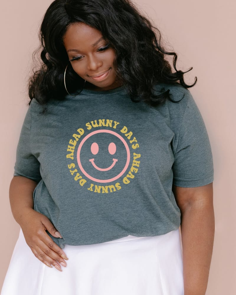 Front of a model wearing a size Large Sunny Days Ahead Smiley Face in Forest by Simply Sage Market. | dia_product_style_image_id:281733